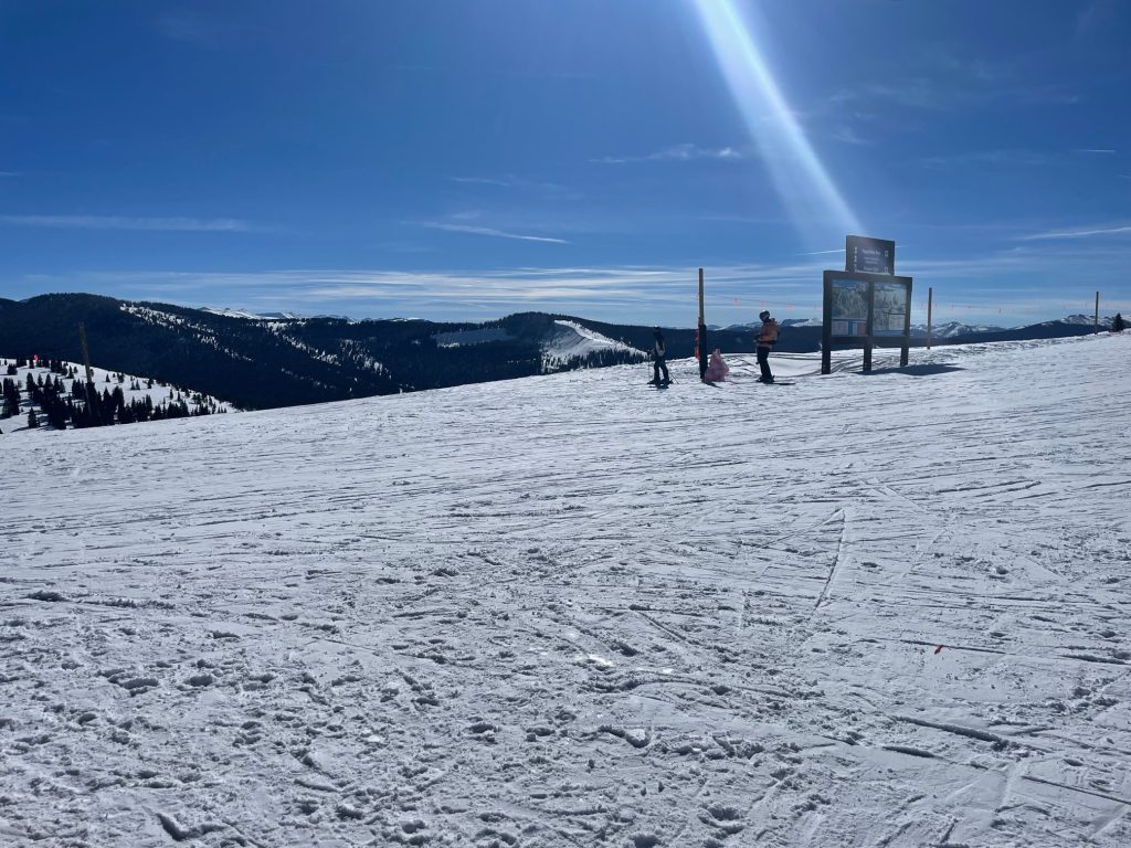 top of a ski mountain on a sunny day